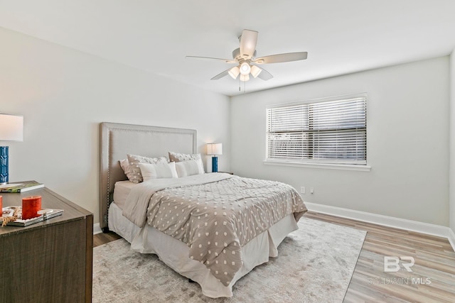 bedroom with ceiling fan and light hardwood / wood-style flooring