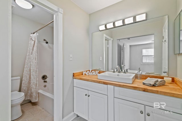 full bathroom featuring tile patterned floors, vanity, shower / tub combo with curtain, and toilet