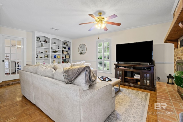 living area featuring a textured ceiling, ceiling fan, and visible vents