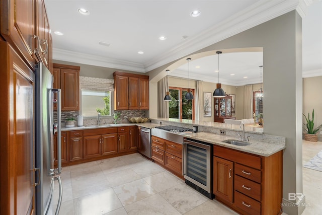 kitchen with a sink, stainless steel appliances, light stone countertops, and beverage cooler
