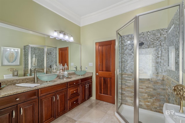 bathroom with tile patterned flooring, crown molding, a stall shower, and a sink