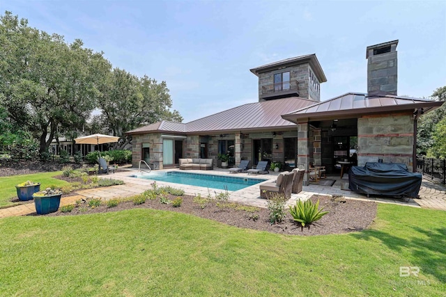 outdoor pool with a yard, a grill, and a patio area