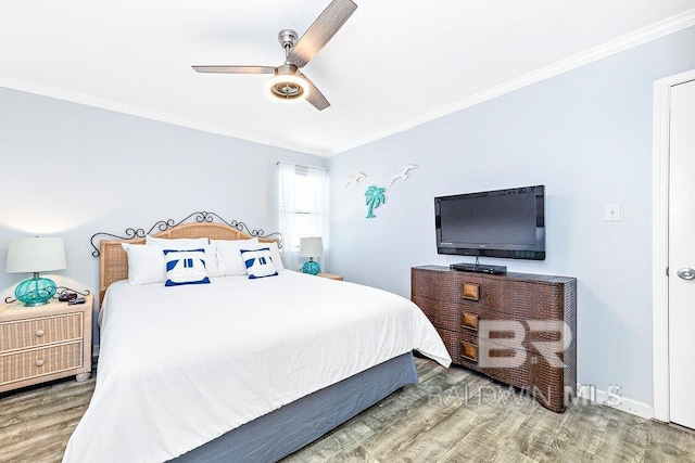 bedroom featuring wood finished floors, crown molding, and a ceiling fan