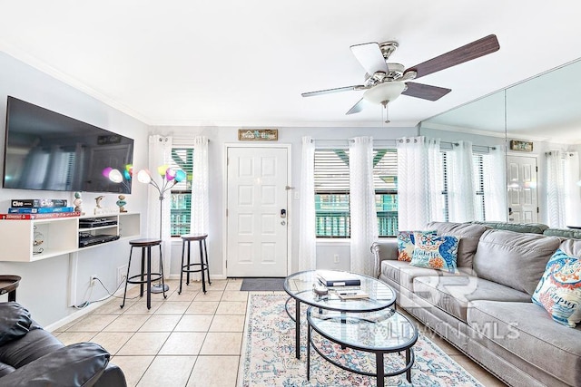 living area with crown molding, ceiling fan, light tile patterned floors, and baseboards