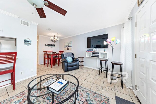 tiled living area with ornamental molding, ceiling fan, a chandelier, and baseboards
