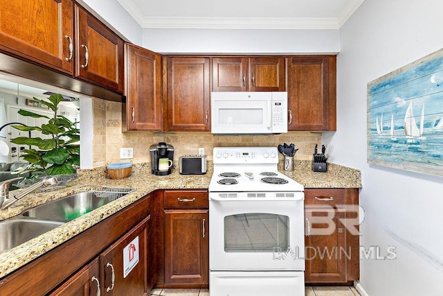 kitchen featuring white appliances, decorative backsplash, light stone countertops, crown molding, and a sink