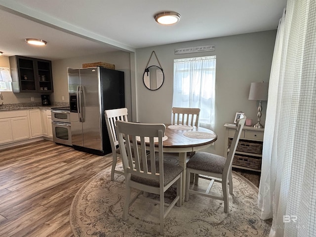 dining space with wood finished floors