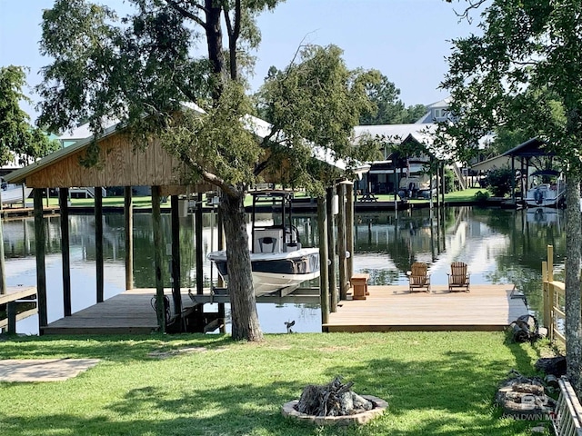 view of dock featuring a yard, a water view, and a fire pit