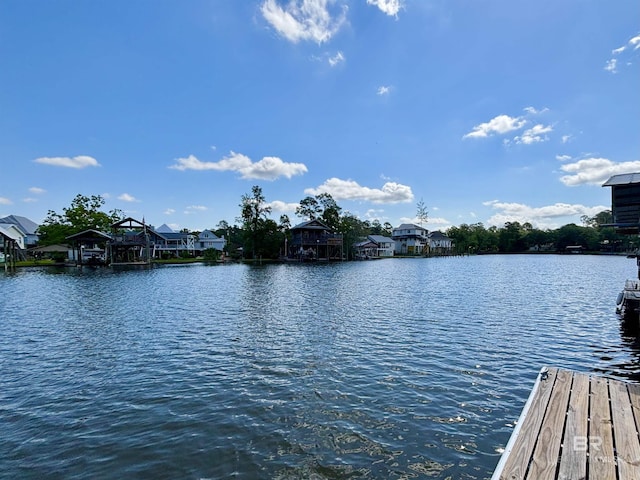 view of dock with a water view and a residential view