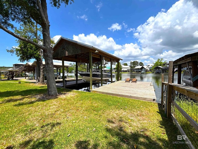 view of dock featuring a lawn, a water view, and boat lift