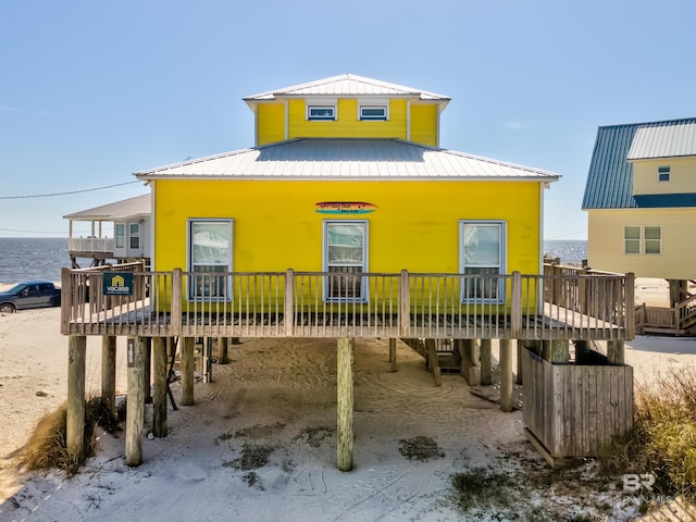 rear view of house with metal roof and a wooden deck