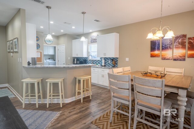 105 Strand Ct, Dauphin Island, AL 36528 - dining room featuring visible vents, dark wood-type flooring, recessed lighting, an inviting chandelier, and washer / dryer