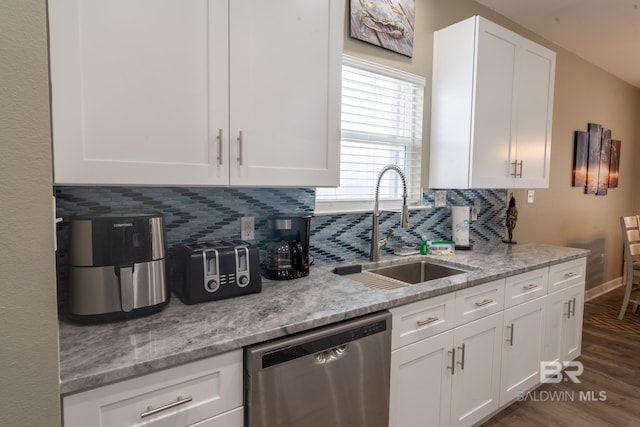 105 Strand Ct, Dauphin Island, AL 36528 - kitchen with stainless steel dishwasher, dark wood-type flooring, white cabinetry, and a sink