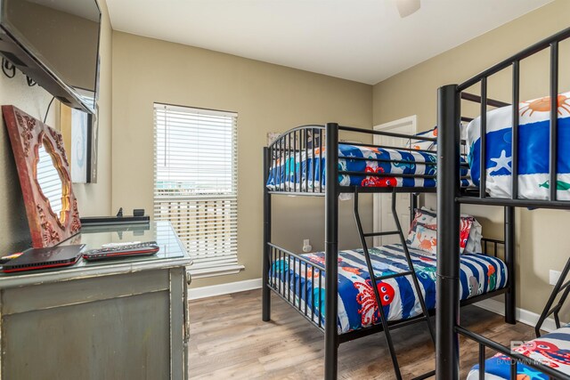 105 Strand Ct, Dauphin Island, AL 36528 - bedroom featuring baseboards and wood finished floors