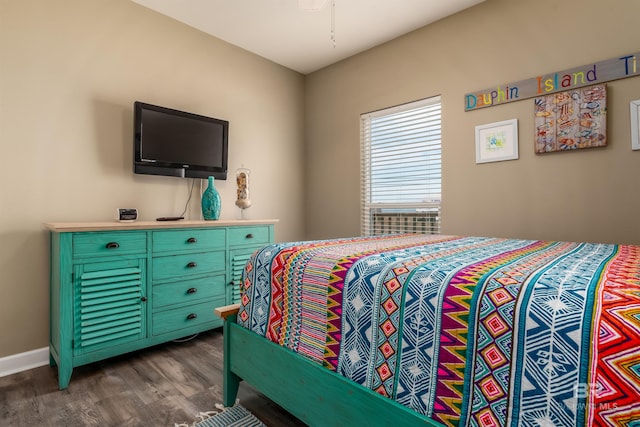 105 Strand Ct, Dauphin Island, AL 36528 - bedroom with baseboards and dark wood-style flooring