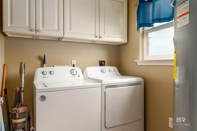 105 Strand Ct, Dauphin Island, AL 36528 - laundry room featuring cabinet space, independent washer and dryer, and water heater