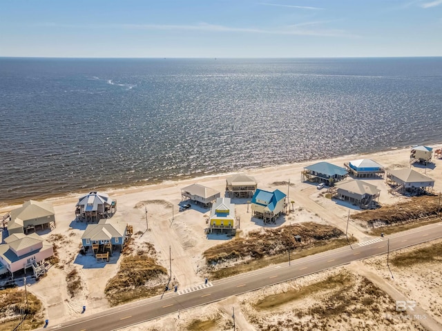 birds eye view of property with a beach view and a water view