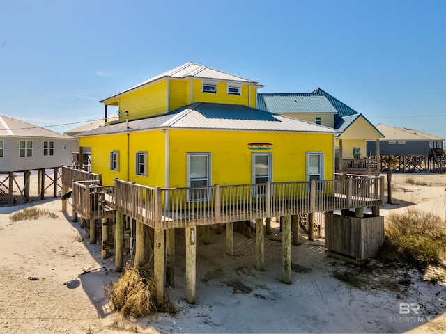 105 Strand Ct, Dauphin Island, AL 36528 - back of property with metal roof and a deck