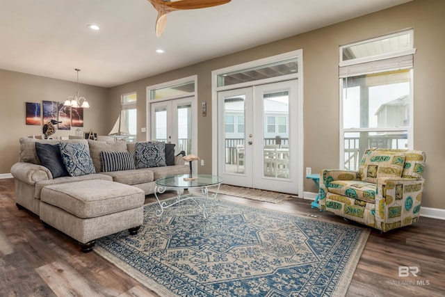 105 Strand Ct, Dauphin Island, AL 36528 - living room with a notable chandelier, wood finished floors, recessed lighting, french doors, and baseboards