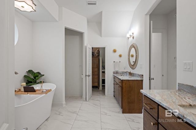 bathroom featuring vanity and a tub to relax in