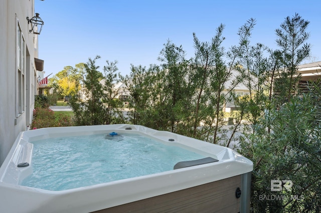 view of swimming pool featuring a hot tub