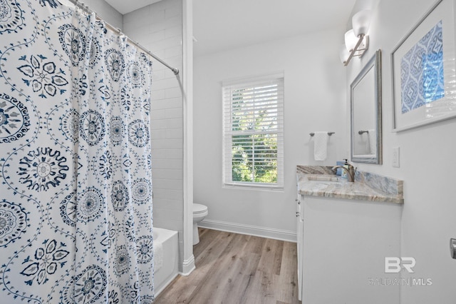 full bathroom with hardwood / wood-style flooring, vanity, toilet, and shower / bath combo