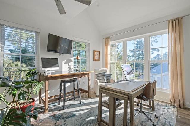 home office featuring hardwood / wood-style floors, vaulted ceiling, and ceiling fan