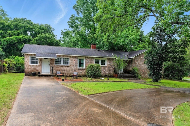 409 E Byron Ave, Mobile, AL 36609 - ranch-style house featuring brick siding, concrete driveway, a chimney, a front lawn, and a shingled roof