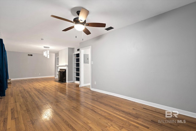409 E Byron Ave, Mobile, AL 36609 - unfurnished living room featuring a ceiling fan, a fireplace with flush hearth, and wood finished floors
