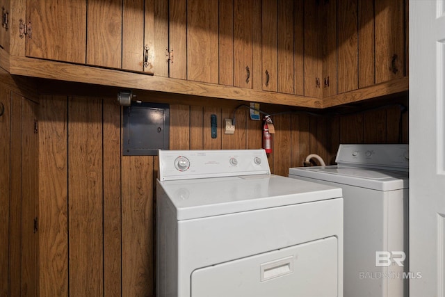 409 E Byron Ave, Mobile, AL 36609 - laundry area with cabinet space, washer and dryer, and wood walls