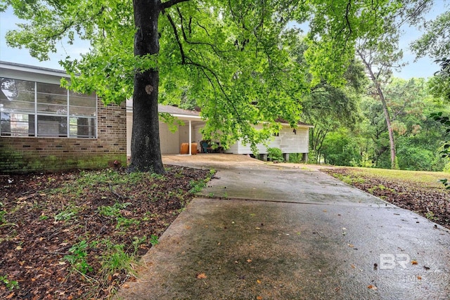 409 E Byron Ave, Mobile, AL 36609 - view of front of property featuring concrete driveway, brick siding, and an attached carport