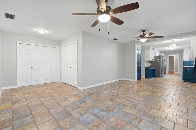 409 E Byron Ave, Mobile, AL 36609 - unfurnished living room featuring a ceiling fan and light stone finish flooring