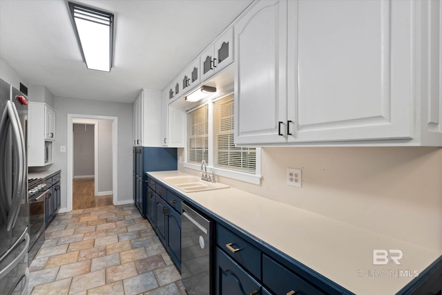 409 E Byron Ave, Mobile, AL 36609 - kitchen featuring appliances with stainless steel finishes, white cabinets, blue cabinetry, light stone finish floors, and light countertops