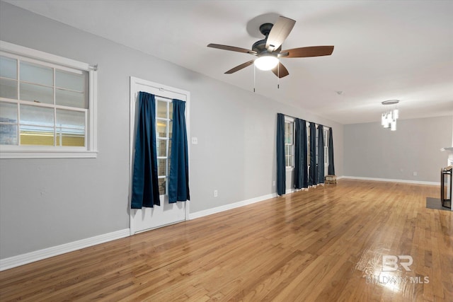 409 E Byron Ave, Mobile, AL 36609 - unfurnished living room with light wood-style floors, ceiling fan, and a chandelier