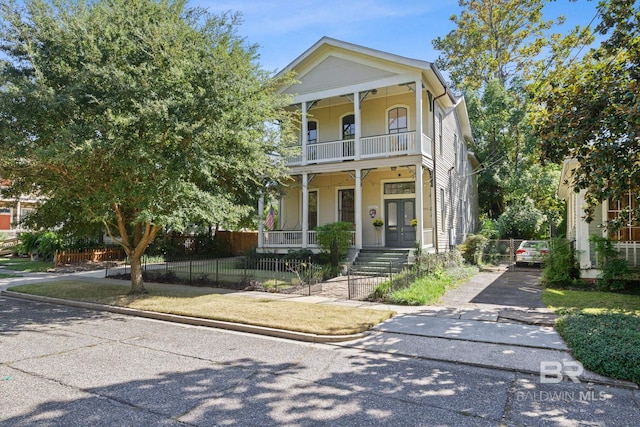 greek revival inspired property with covered porch and a balcony