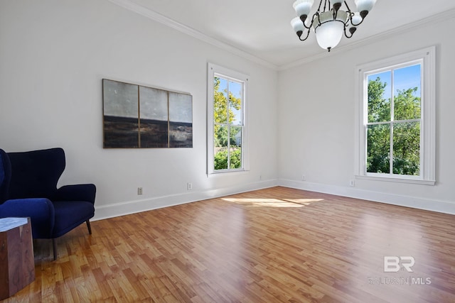 sitting room featuring crown molding, a chandelier, and hardwood / wood-style floors