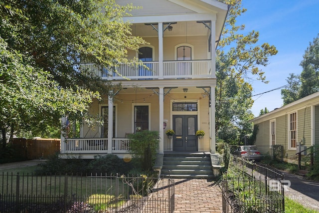 view of front facade featuring covered porch and a balcony