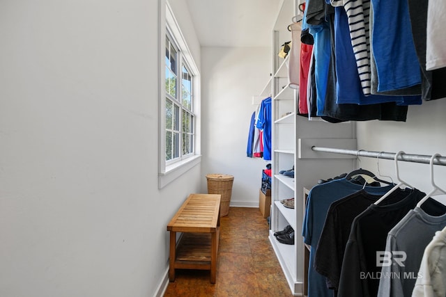 spacious closet with dark tile patterned flooring