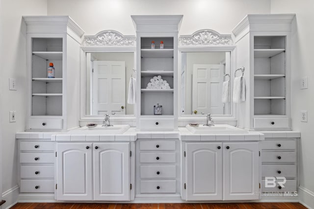 bathroom featuring vanity, hardwood / wood-style floors, and built in features