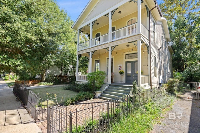 view of front of property featuring covered porch and a balcony