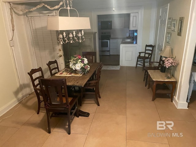 dining area featuring baseboards and light tile patterned floors