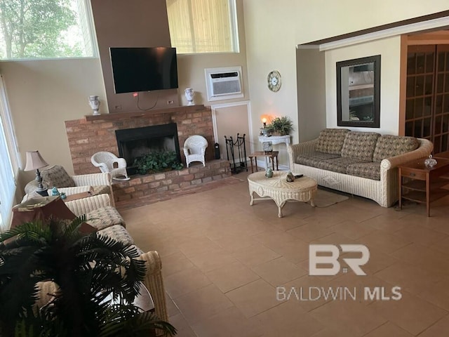 living room featuring a brick fireplace, tile patterned flooring, and a wall mounted AC