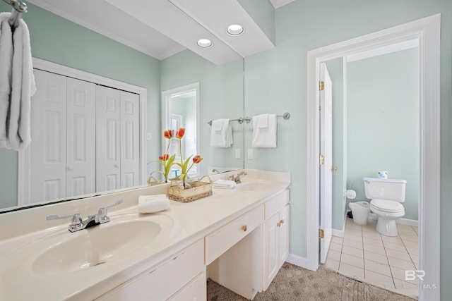 307 Audubon Pl, Dauphin Island, AL 36528 - full bathroom with double vanity, toilet, baseboards, and a sink