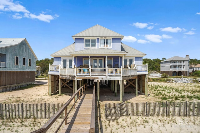 307 Audubon Pl, Dauphin Island, AL 36528 - back of house featuring french doors, a carport, fence private yard, and a deck