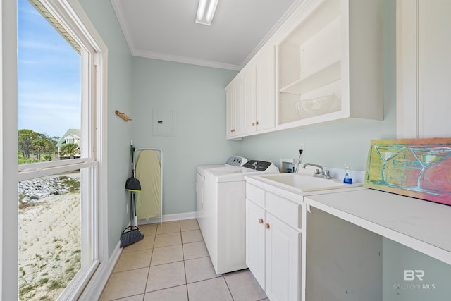 307 Audubon Pl, Dauphin Island, AL 36528 - laundry area with cabinet space, a sink, ornamental molding, light tile patterned floors, and washing machine and dryer