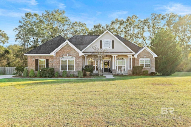 view of front of home with a front yard and a porch