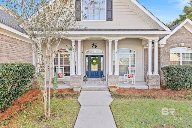 view of exterior entry featuring a porch