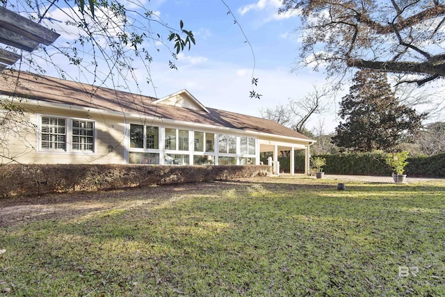 back of house featuring a yard