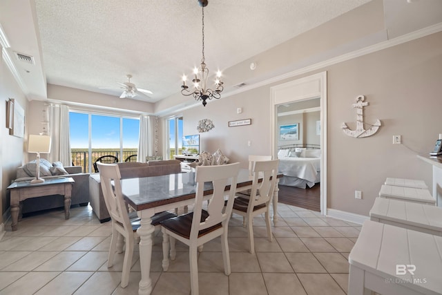 tiled dining room with a textured ceiling and ceiling fan with notable chandelier