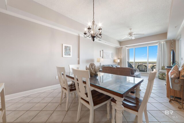 dining space with ceiling fan with notable chandelier, a textured ceiling, and light tile patterned floors